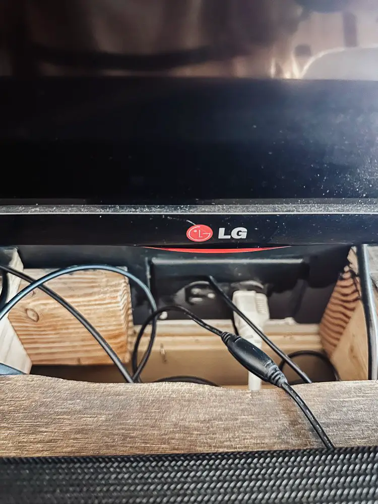 Insert cut out of DIY wood mantel for cords