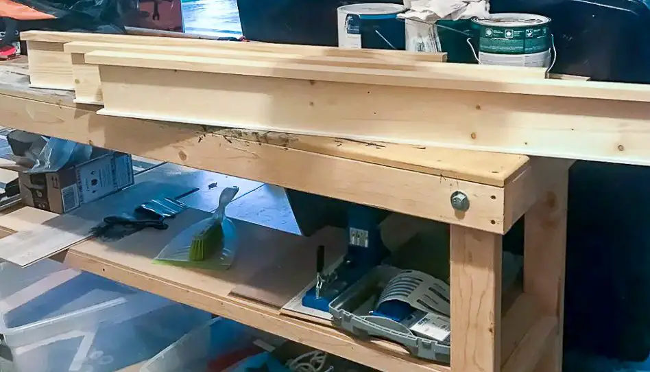 Top of a door frame (install craftsman trim) built and sitting on a tool bench.