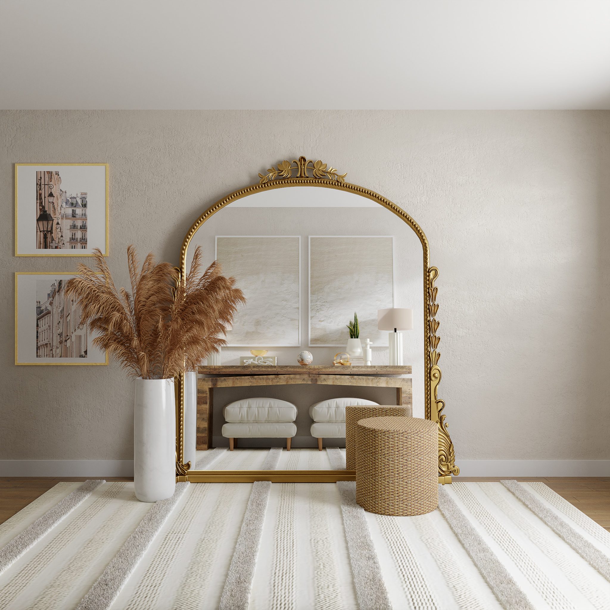 An oversized arched mirror with a jute pouf in front of it and ornamental stems.