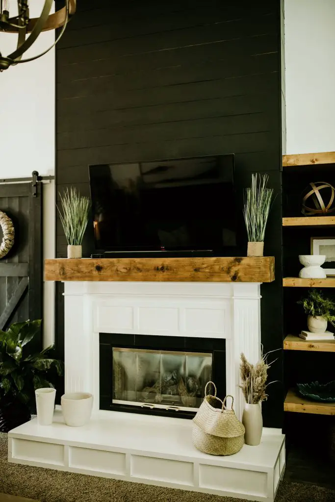 Fireplace with a tv above it.