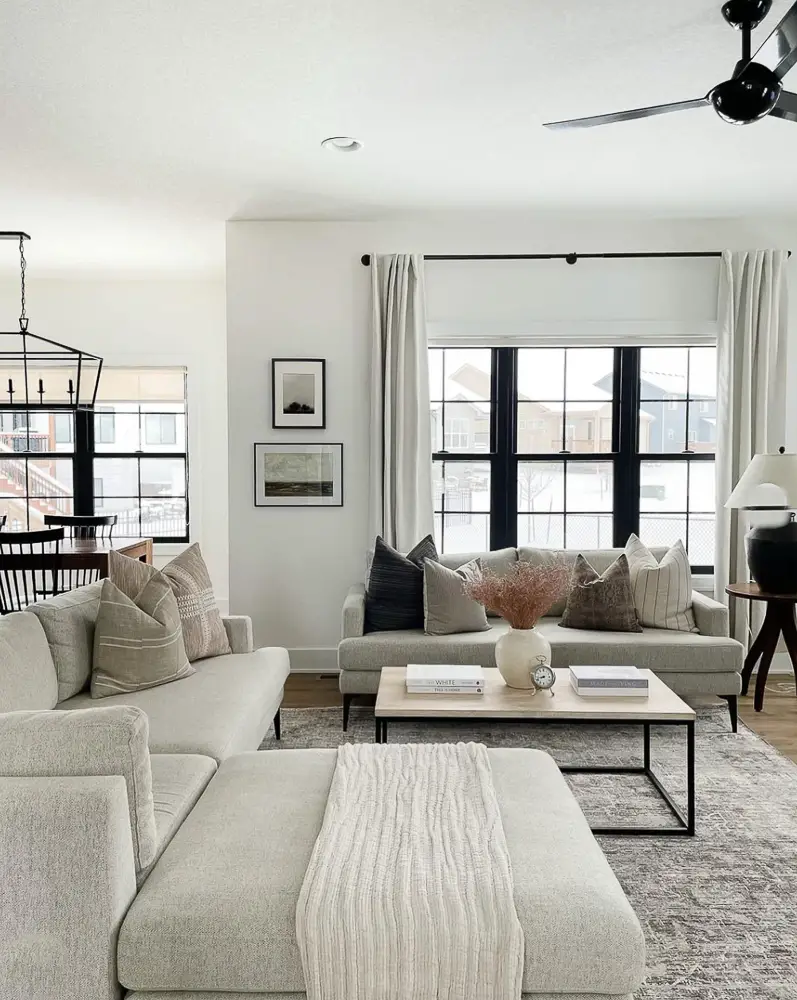 Living room with large windows/ roman shades/linen curtains.