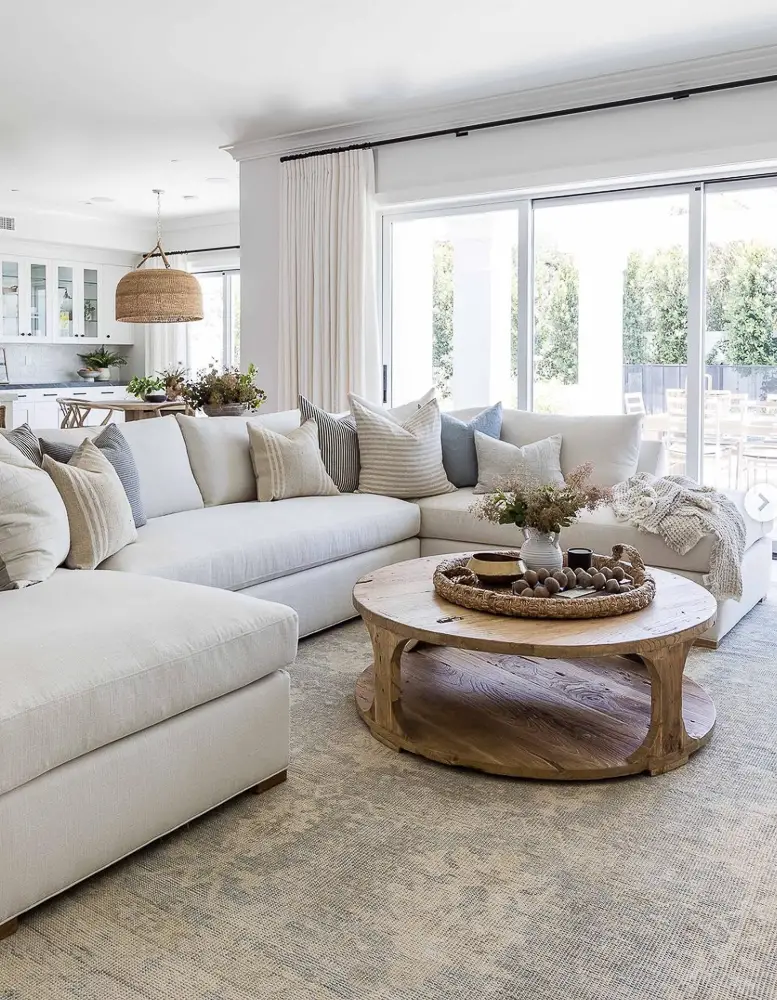 Sitting area with large picture windows for the right way to hang curtains.