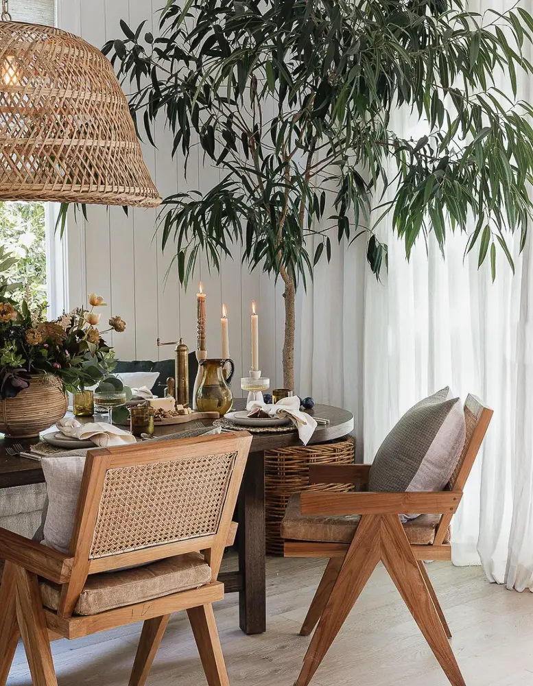 Dining area with a large ficus tree.