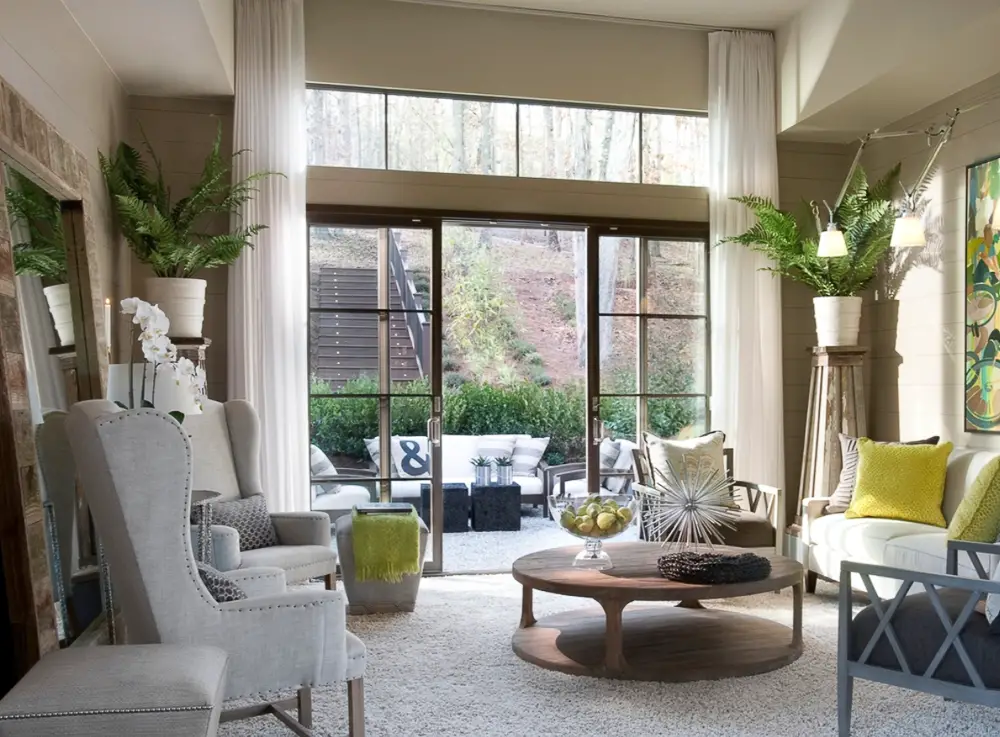 Large picture windows with huge sheer curtains hanging down.