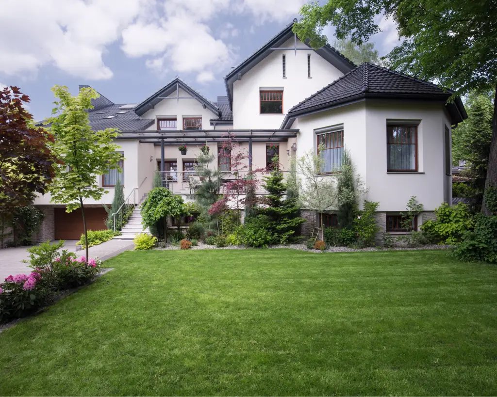 White home with a beautiful front yard.