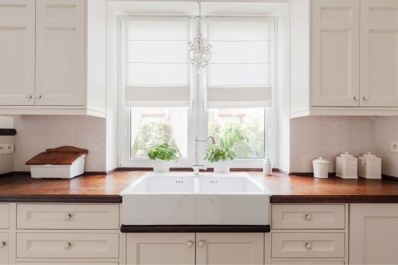 Kitchen sink in front of kitchen window.