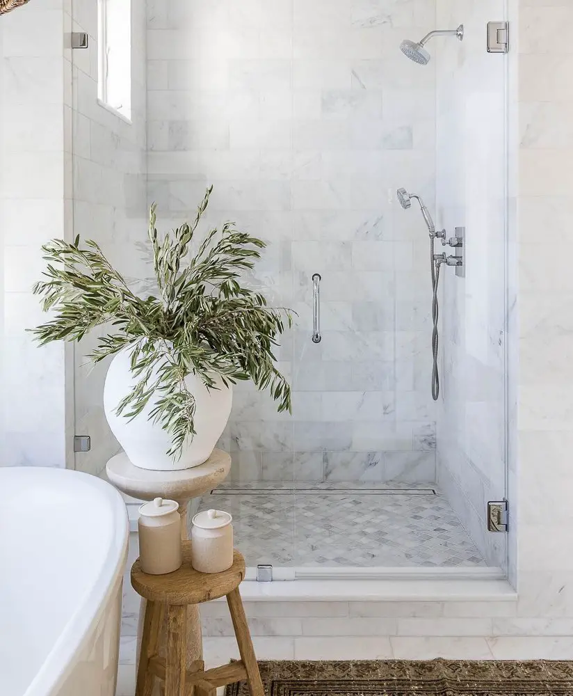 Walk-in shower with beautiful marble walls and floor.