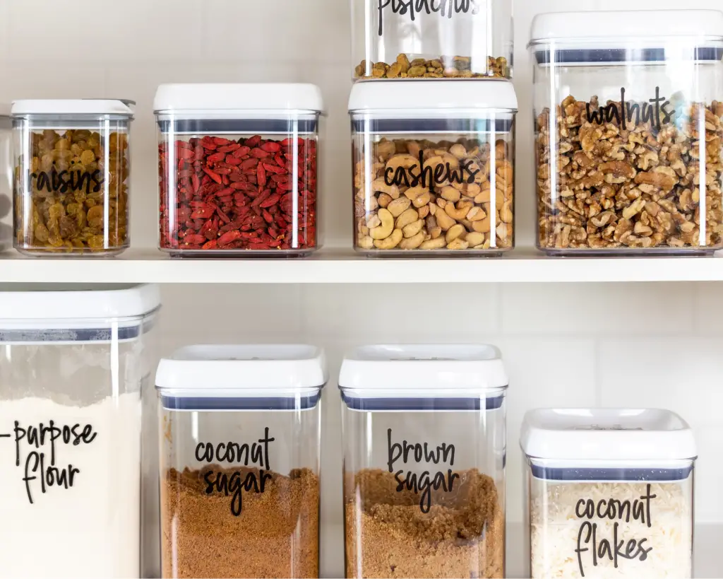 Plastic storage bins in a pantry.