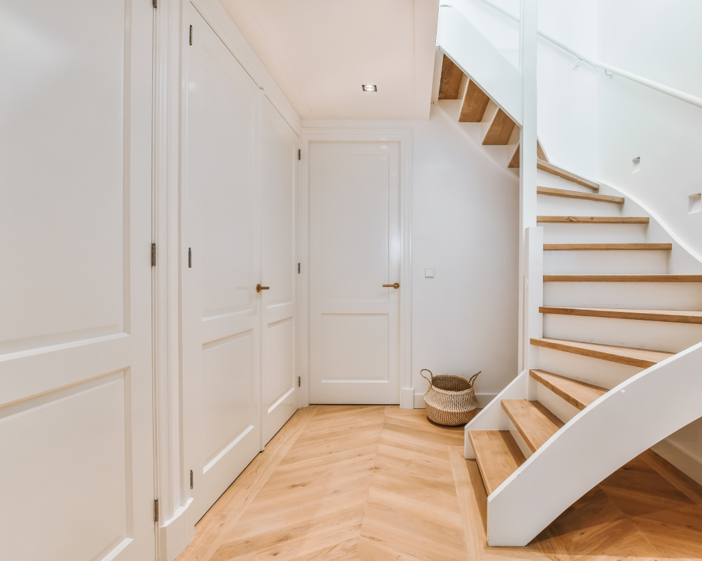 A winding stair case with warm wood tones.