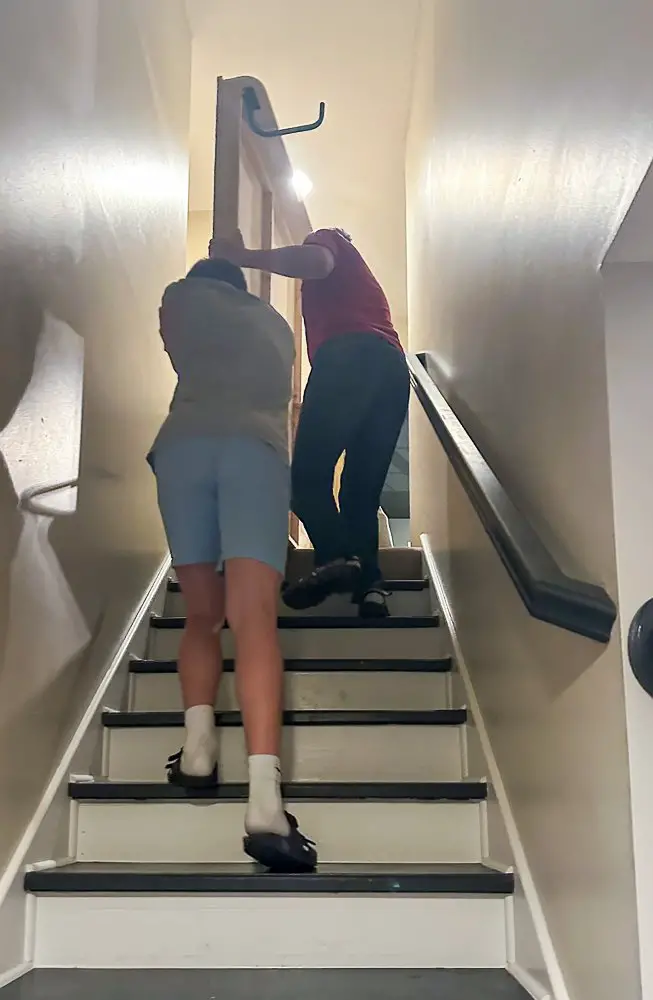 2 guys carrying a murphy bed upstairs for Home Office Guest Room Reveal.