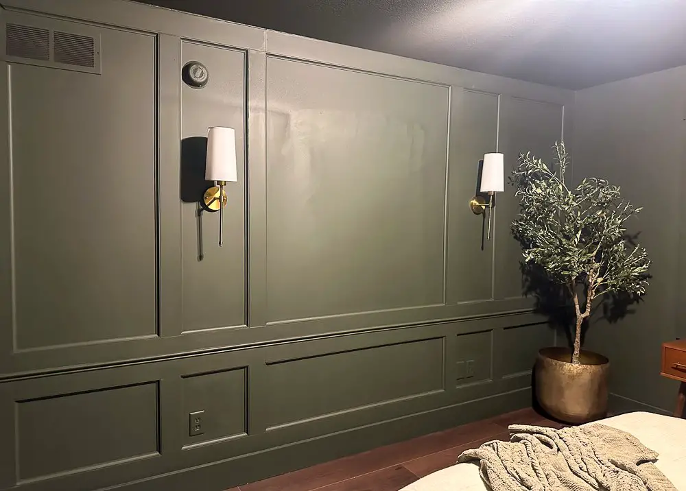 Long millwork wall with wall sconces.