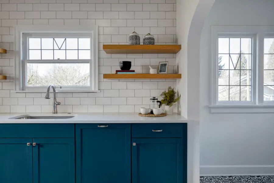 Kitchen with open shelving and blue cabinets.