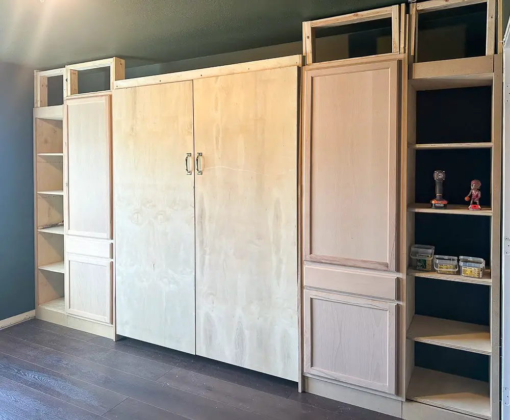 A murphy bed built-ins wall with toppers being framed out.
