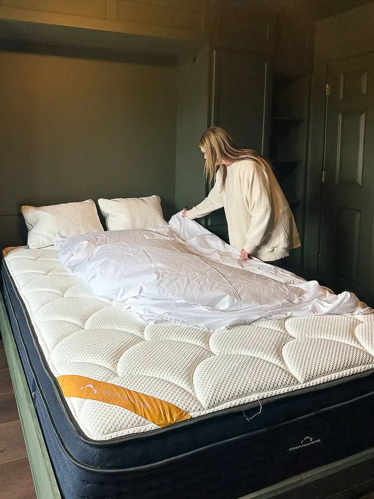 A girl making a bed for Murphy Bed Benefits post.
