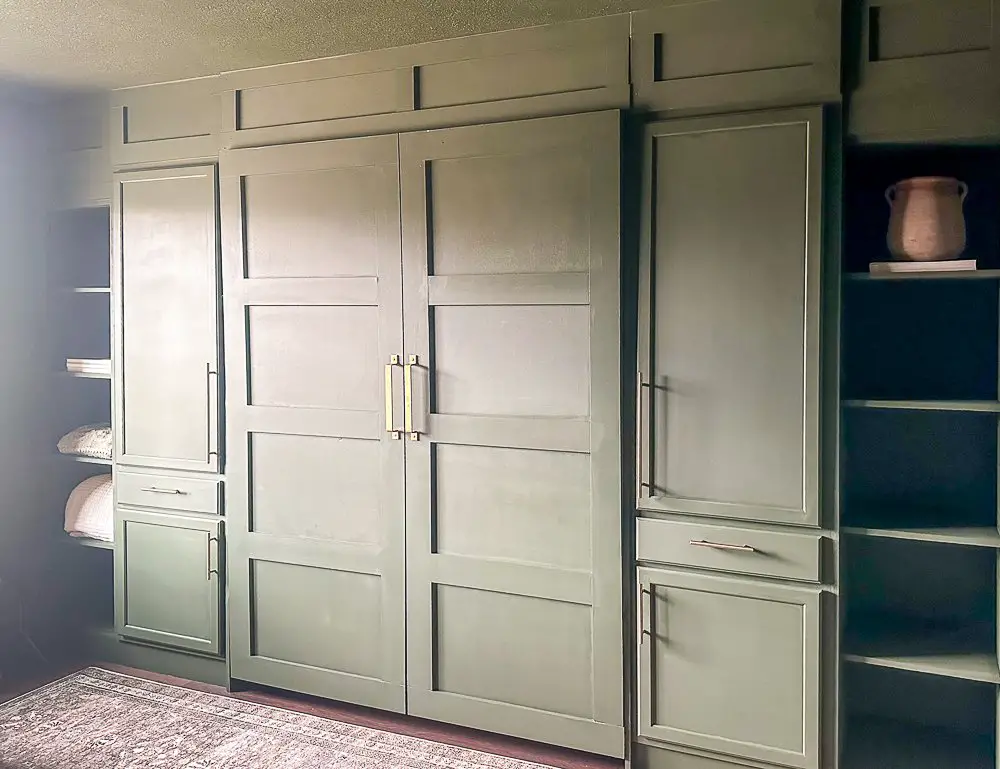 Wall of built-ins painted green.