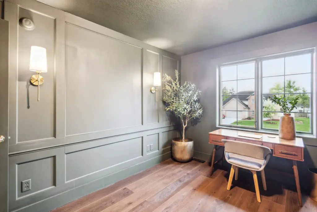 Home office with an olive tree and a desk for combine a home office and guest room post.