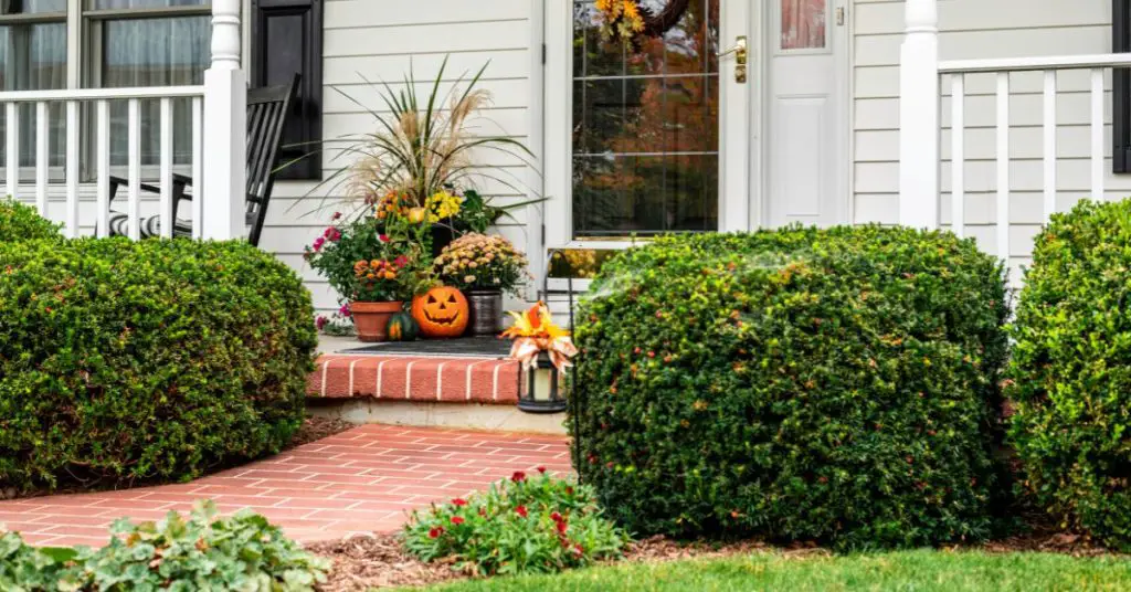 Front porch decorated for fall.