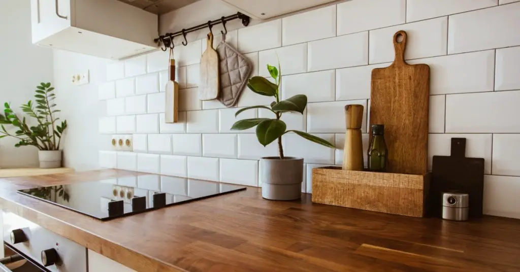 Kitchen with a subway tile backsplash and butcher block countertops.